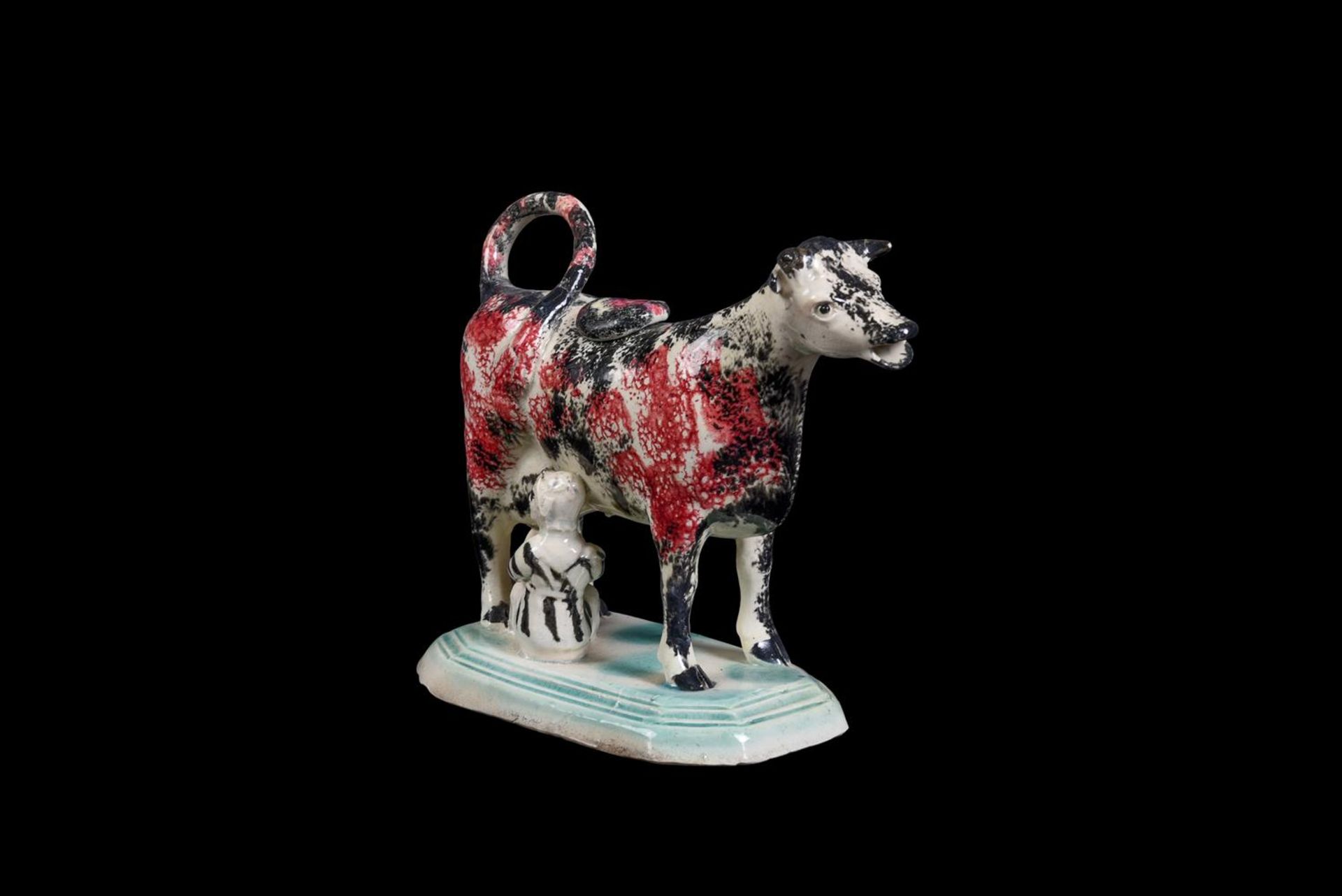 AN ENGLISH PEARLWARE SPONGE-DECORATED COW-CREAMER WITH MILKMAID