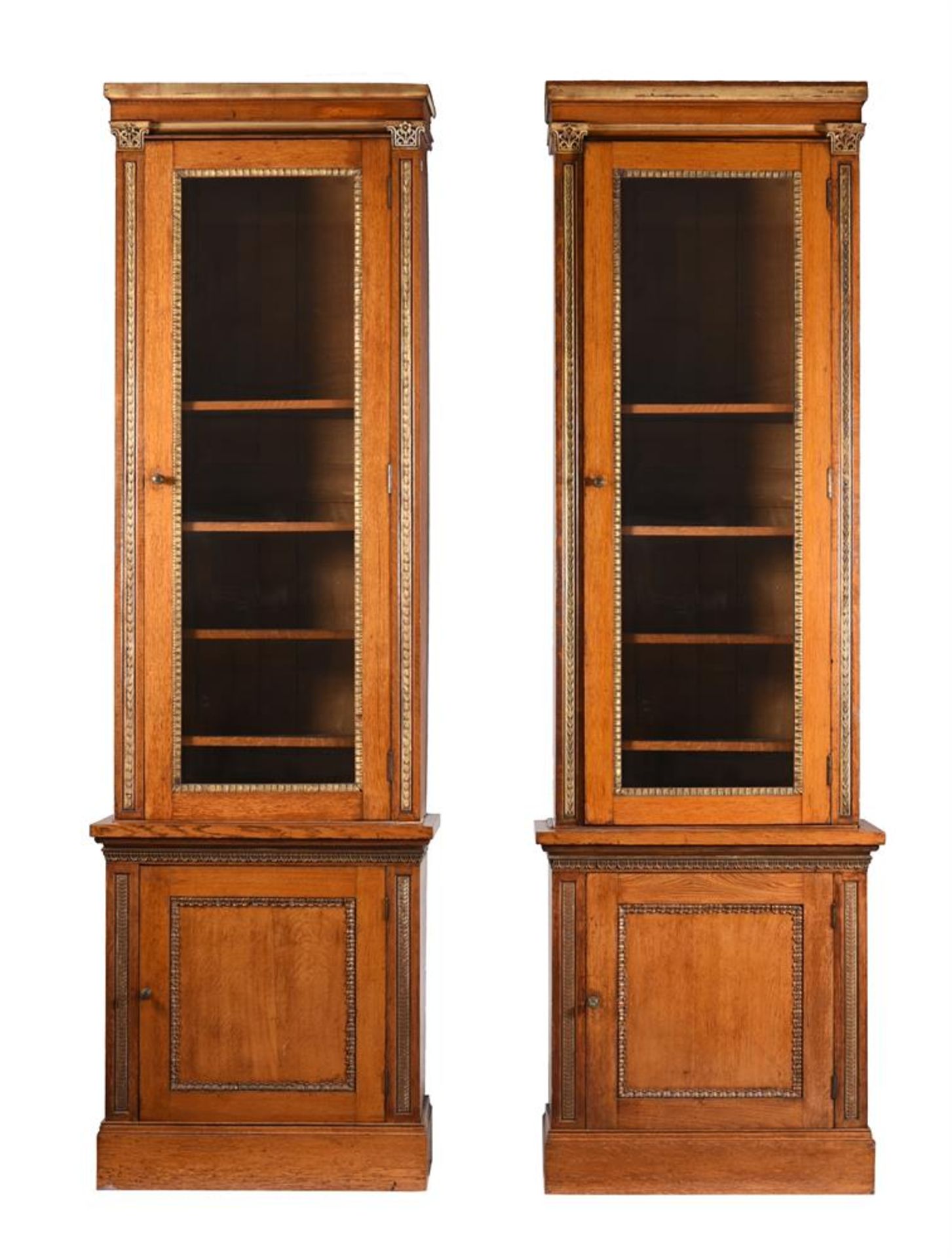 A PAIR OF VICTORIAN OAK AND PARCEL GILT BOOKCASES