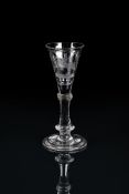 AN ENGRAVED WILLIAMITE WINE GLASS OF THE TYPE FROM THE PUGH BROTHERS STUDIOS