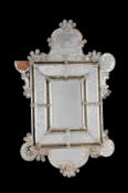 A VENETIAN MOULDED AND ETCHED GLASS WALL MIRROR