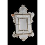 A VENETIAN MOULDED AND ETCHED GLASS WALL MIRROR
