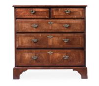 A WALNUT AND CROSSBANDED CHEST OF DRAWERS