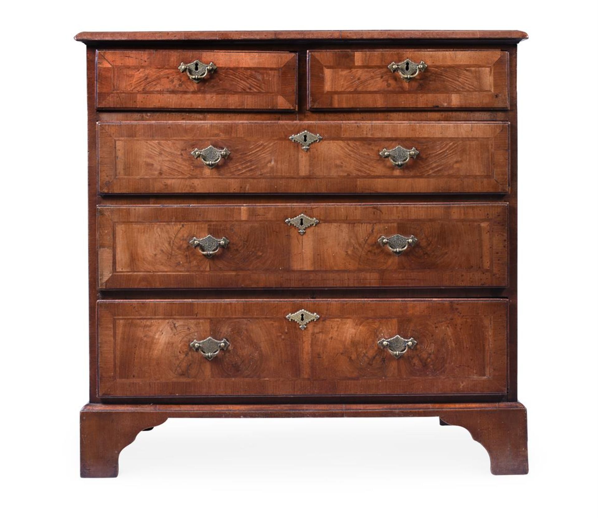 A WALNUT AND CROSSBANDED CHEST OF DRAWERS
