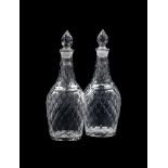 A PAIR OF CUT GLASS DECANTERS AND STOPPERS