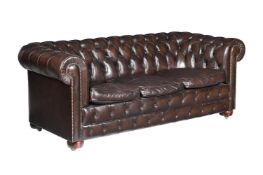 A BROWN LEATHER UPHOLSTERED SOFA IN VICTORIAN STYLE