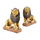 A PAIR OF POLYCHROME PAINTED STONEWARE LIONS