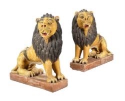 A PAIR OF POLYCHROME PAINTED STONEWARE LIONS