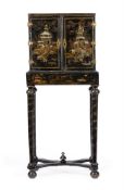 Y A BLACK LACQUER, GILT CHINOISERIE AND MOTHER OF PEARL INLAID CABINET ON STAND