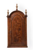 A QUEEN ANNE WALNUT AND FEATHER-BANDED HANGING CORNER CUPBOARD, CIRCA 1710