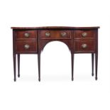 Y A GEORGE III MAHOGANY AND KINGWOOD BANDED SERPENTINE FRONTED SIDEBOARD, CIRCA 1790