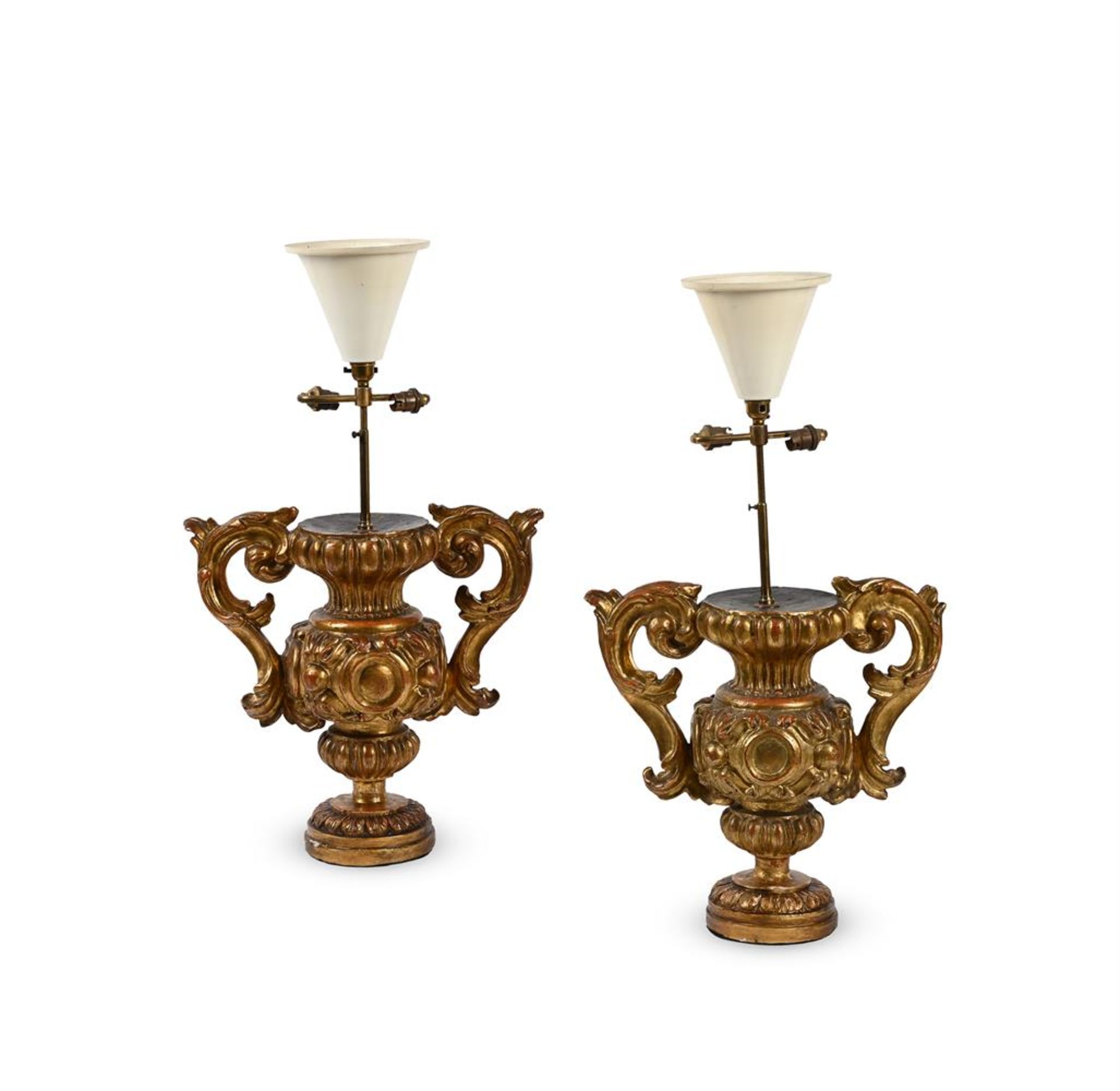 A PAIR OF ITALIAN CARVED AND GILTWOOD URN LAMP BASES, EARLY 18TH CENTURY AND LATER ADAPTED