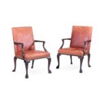 A PAIR OF CARVED MAHOGANY AND LEATHER UPHOLSTERED ARMCHAIRS, IN GEORGE II STYLE, 20TH CENTURY