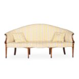 A GEORGE III MAHOGANY AND UPHOLSTERED SERPENTINE SHAPED SOFAIN THE MANNER OF GEORGE HEPPLEWHITE