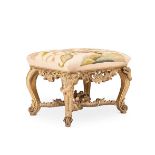 A CARVED GILTWOOD STOOL, PROBABLY GERMAN, IN THE MANNER OF FERDINAND TIETZ, CIRCA 1730