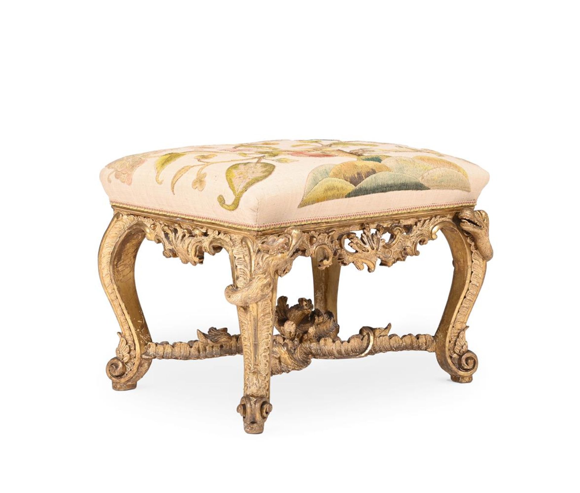 A CARVED GILTWOOD STOOL, PROBABLY GERMAN, IN THE MANNER OF FERDINAND TIETZ, CIRCA 1730