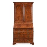 A GEORGE II FIGURED WALNUT AND FEATHER-BANDED BUREAU BOOKCASE, IN THE MANNER OF COXED & WOSTER