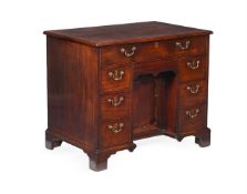 AN EARLY GEORGE III MAHOGANY KNEEHOLE DESK, IN THE MANNER OF GILES GRENDEY, CIRCA 1760