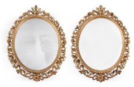 A PAIR OF GILTWOOD AND COMPOSITION OVAL MIRRORS, SECOND HALF 19TH CENTURY