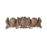 A CARVED LIMEWOOD ARMORIAL OVERDOOR OR PEDIMENT IN THE MANNER OF GRINLING GIBBONS, 19TH CENTURY