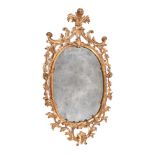 A GEORGE III CARVED GILTWOOD OVAL MIRROR, CIRCA 1770