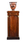 A CONTINENTAL MAHOGANY AND PARCEL GILT PEDESTAL CABINET, PROBABLY FRENCH, FIRST HALF 19TH CENTURY