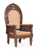 AN ANGLO-INDIAN CARVED HARDWOOD ARMCHAIR, MID 19TH CENTURY