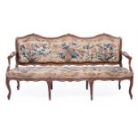 A CARVED OAK AND UPHOLSTERED SETTEE, LATE 18TH OR EARLY 19TH CENTURY