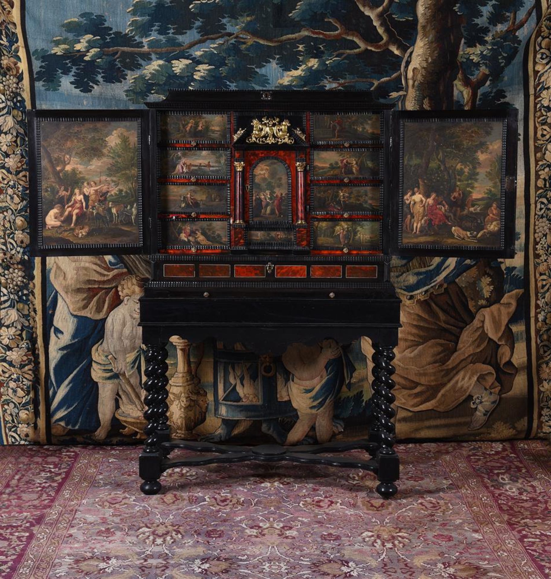 Y A FLEMISH EBONY, TORTOISESHELL AND POLYCHROME PAINTED CABINET ON STAND