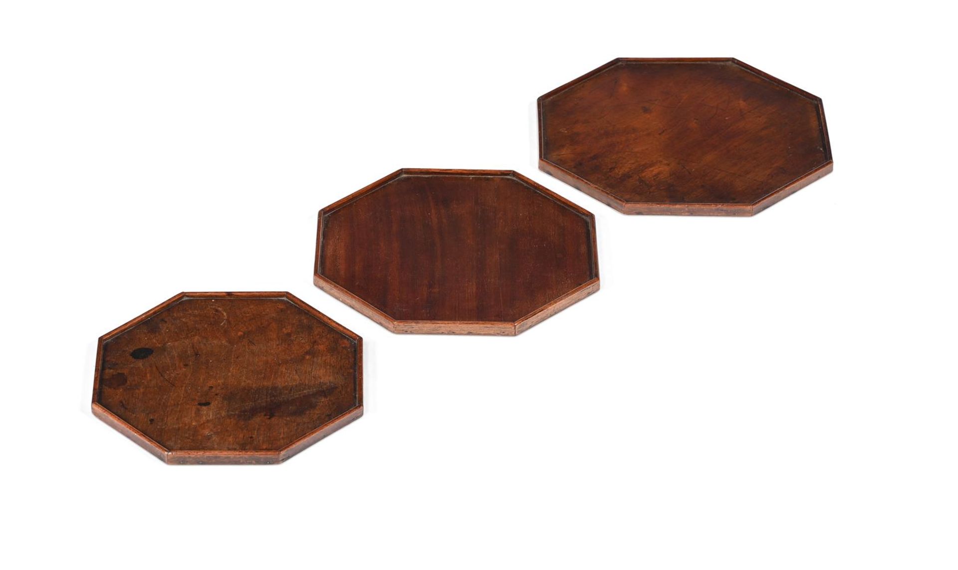 A RARE SET OF THREE GEORGE III MAHOGANY GRADUATED OCTAGONAL TRAYS, 18TH CENTURY