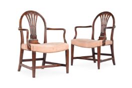 A PAIR OF GEORGE III MAHOGANY OPEN ARMCHAIRS AFTER DESIGNS BY GEORGE HEPPLEWHITE