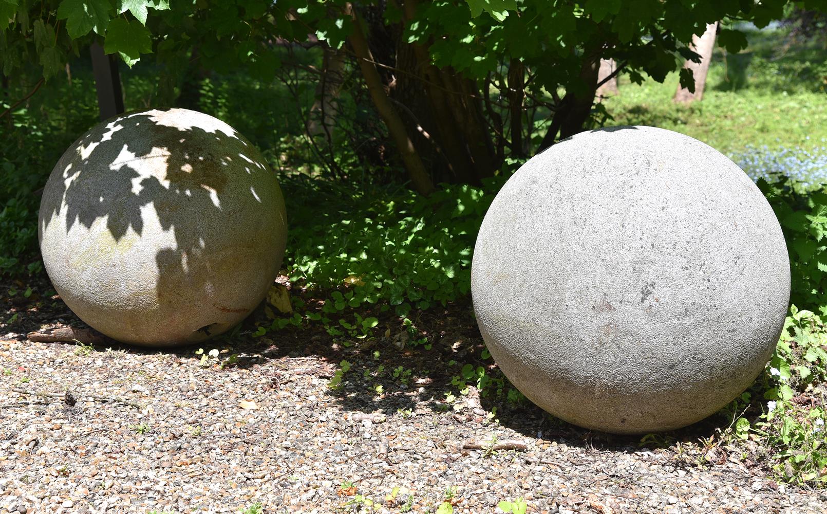A PAIR OF MONUMENTAL CARVED GRANITE BALLS,20TH CENTURY
