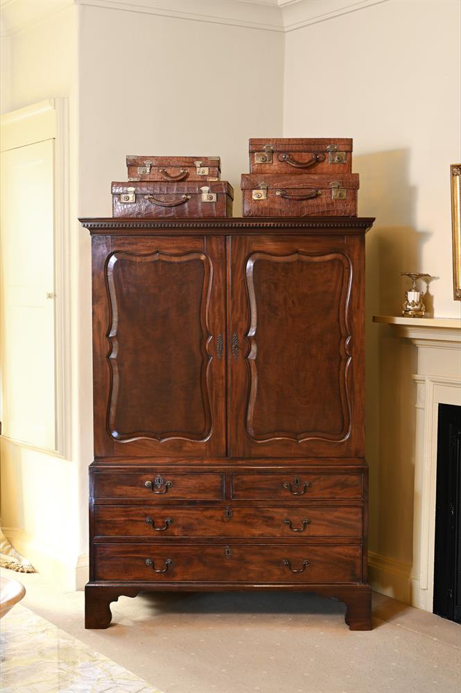 A GEORGE III 'FIDDLEBACK' MAHOGANY CLOTHES PRESS, IN THE MANNER OF GILES GRENDEY, CIRCA 1790