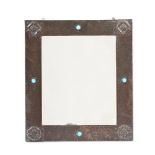 AN ARTS AND CRAFTS HAMMERED COPPER AND TURQUOISE ENAMEL WALL MIRROR, BY LIBERTY & CO