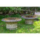 A LARGE PAIR OF MOSS WEATHERED COMPOSITION STONE GARDEN URNS, LATE 20TH CENTURY