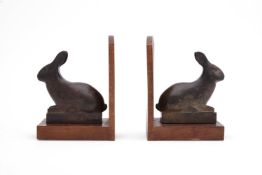 AFTER FRANCOIS POMPOM, A PAIR OF BRONZE AND WOOD RABBIT BOOKENDS