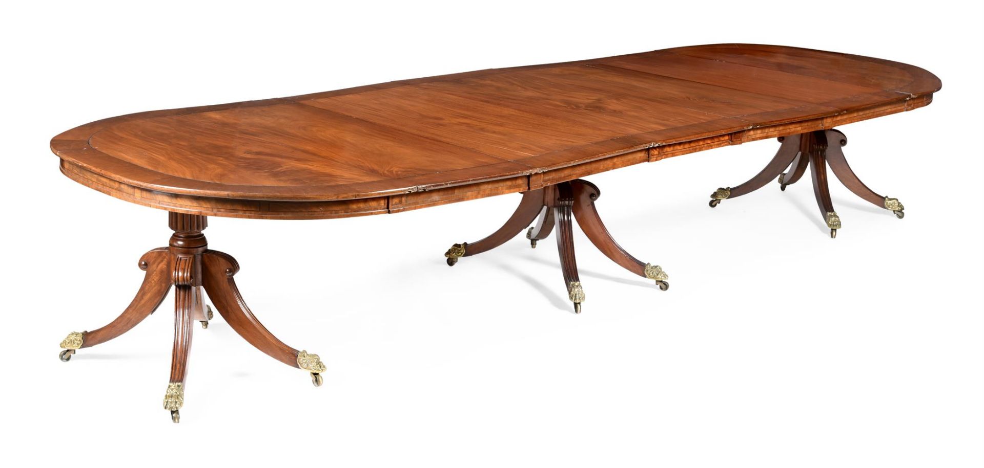 Y A REGENCY MAHOGANY AND EBONY INLAID TRIPLE PEDESTAL DINING TABLE, DUBLIN, CIRCA 1820 AND LATER