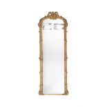 A GILTWOOD AND COMPOSITION WALL MIRROR, 19TH CENTURY
