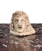 A CARVED WHITE MARBLE ACROTERIUM CORNER STONE OF MEDUSA, ITALIAN, 18TH OR 19TH CENTURY