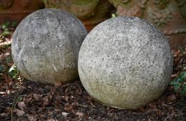 A PAIR OF WEATHERED COMPOSITION STONE BALL FINIALS, MODERN