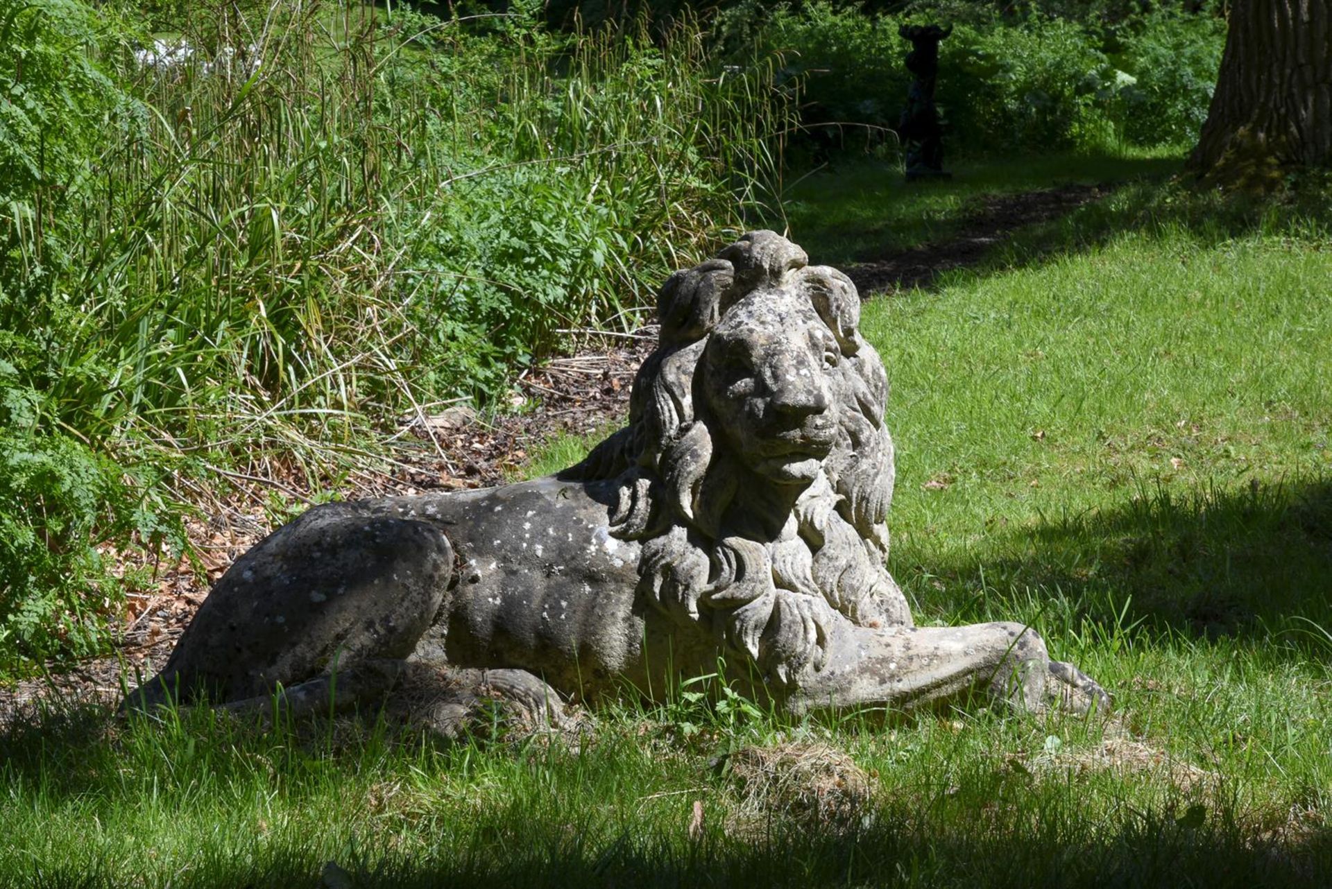 A PAIR OF COMPOSITION STONE MODELS OF RECUMBENT LIONS, AFTER CANOVA, 20TH CENTURY - Image 2 of 3