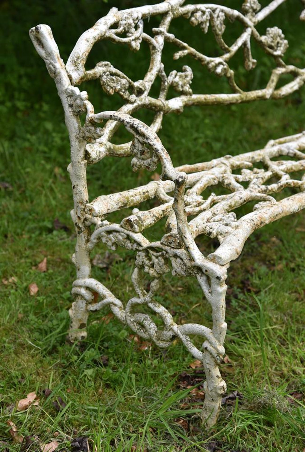 A WEATHERED WHITE PAINTED CAST IRON 'GARDEN BRANCH' BENCH, PROBABLY EARLY 20TH CENTURY - Image 3 of 3