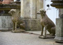 A PAIR OF COMPOSITION STONE MODELS OF SEATED HOUNDS, 20TH CENTURY