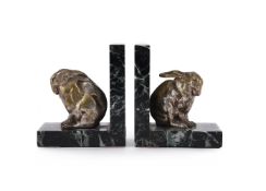 ATTRIBUTED TO OTTENWALD, A PAIR OF ART DECO SILVERED BRONZE AND MARBLE RABBIT BOOKENDS
