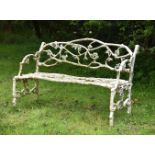 A WEATHERED WHITE PAINTED CAST IRON 'GARDEN BRANCH' BENCH, PROBABLY EARLY 20TH CENTURY