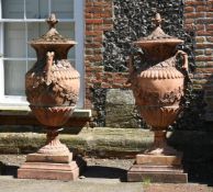 A PAIR OF LARGE TERRACOTTA COLOURED COMPOSITION STONE GARDEN URNS, 20TH CENTURY