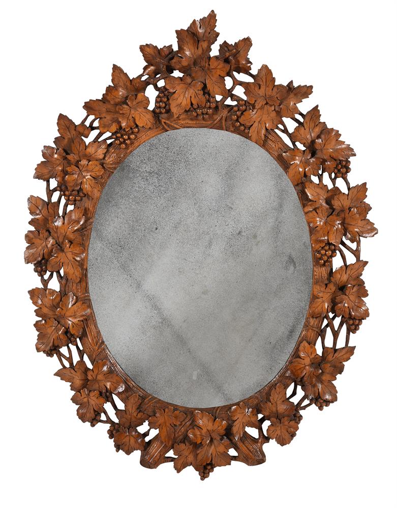 A GERMAN 'BLACK FOREST' CARVED SOFTWOOD OVAL MIRROR, LATE 19TH CENTURY