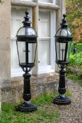 A LARGE PAIR OF BLACK PAINTED CAST IRON AND METAL GARDEN LAMPS, PROBABLY EARLY OR MID 20TH CENTURY