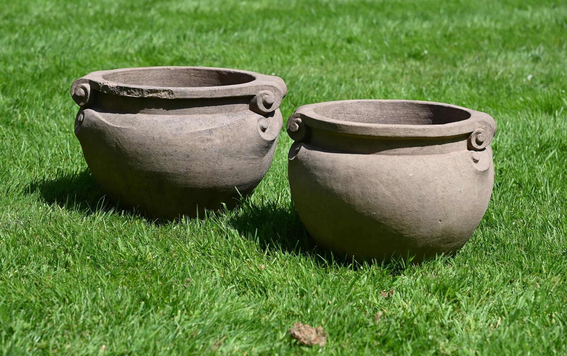 A MATCHED PAIR OF TERRACOTTA SCROLL POTS, BY THE COMPTON POTTERY, CIRCA 1920