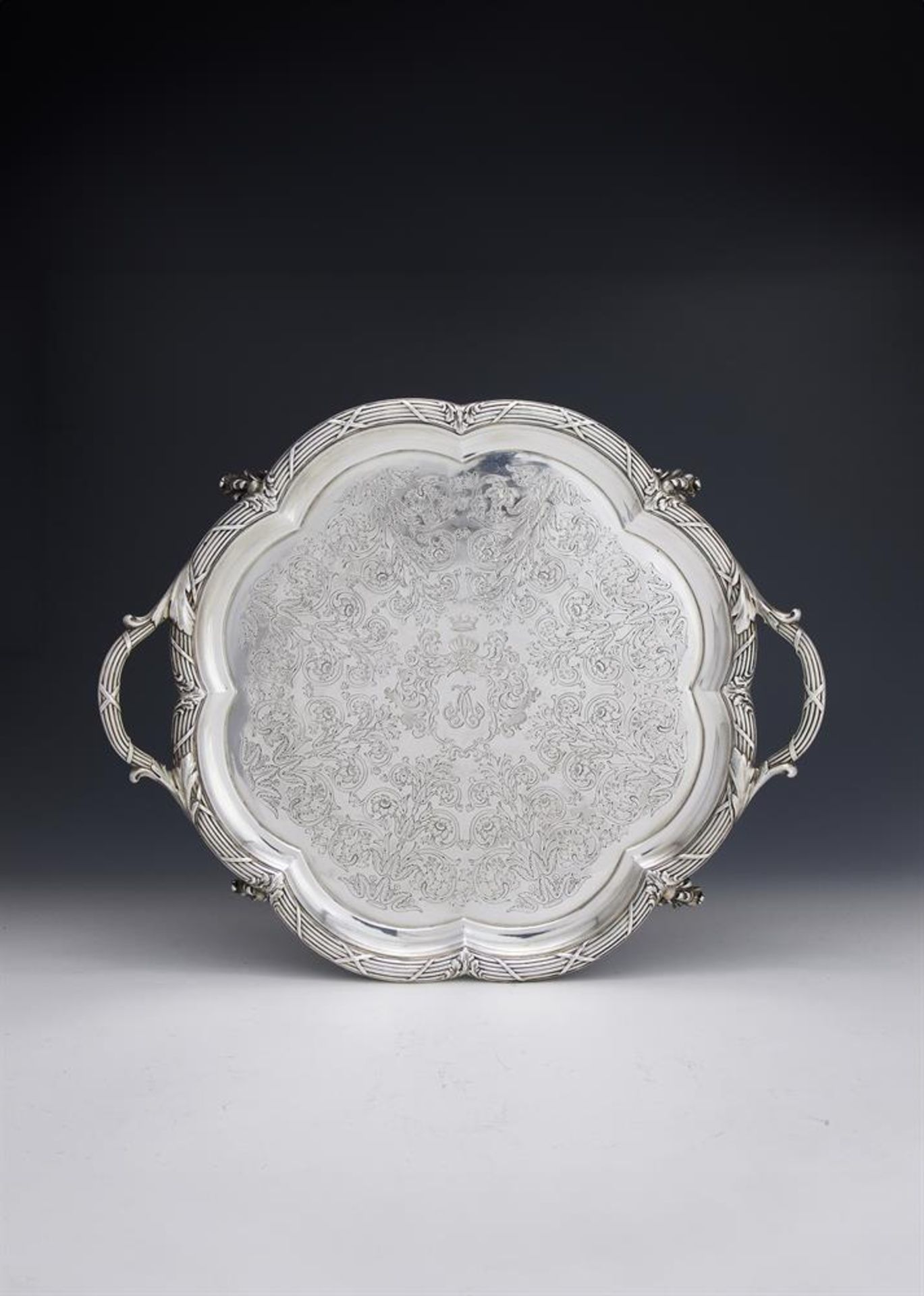 AN EARLY VICTORIAN SILVER TWIN HANDLED SHAPED CIRCULAR TRAY