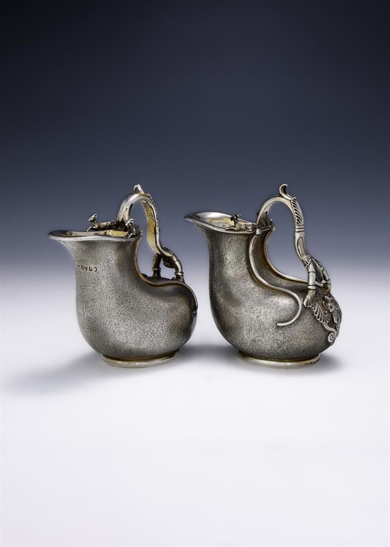 A MATCHED PAIR OF VICTORIAN SILVER ASKOS JUGS